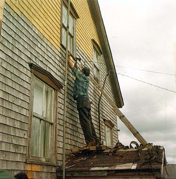 Uncle Bennie working on old house, c1981.