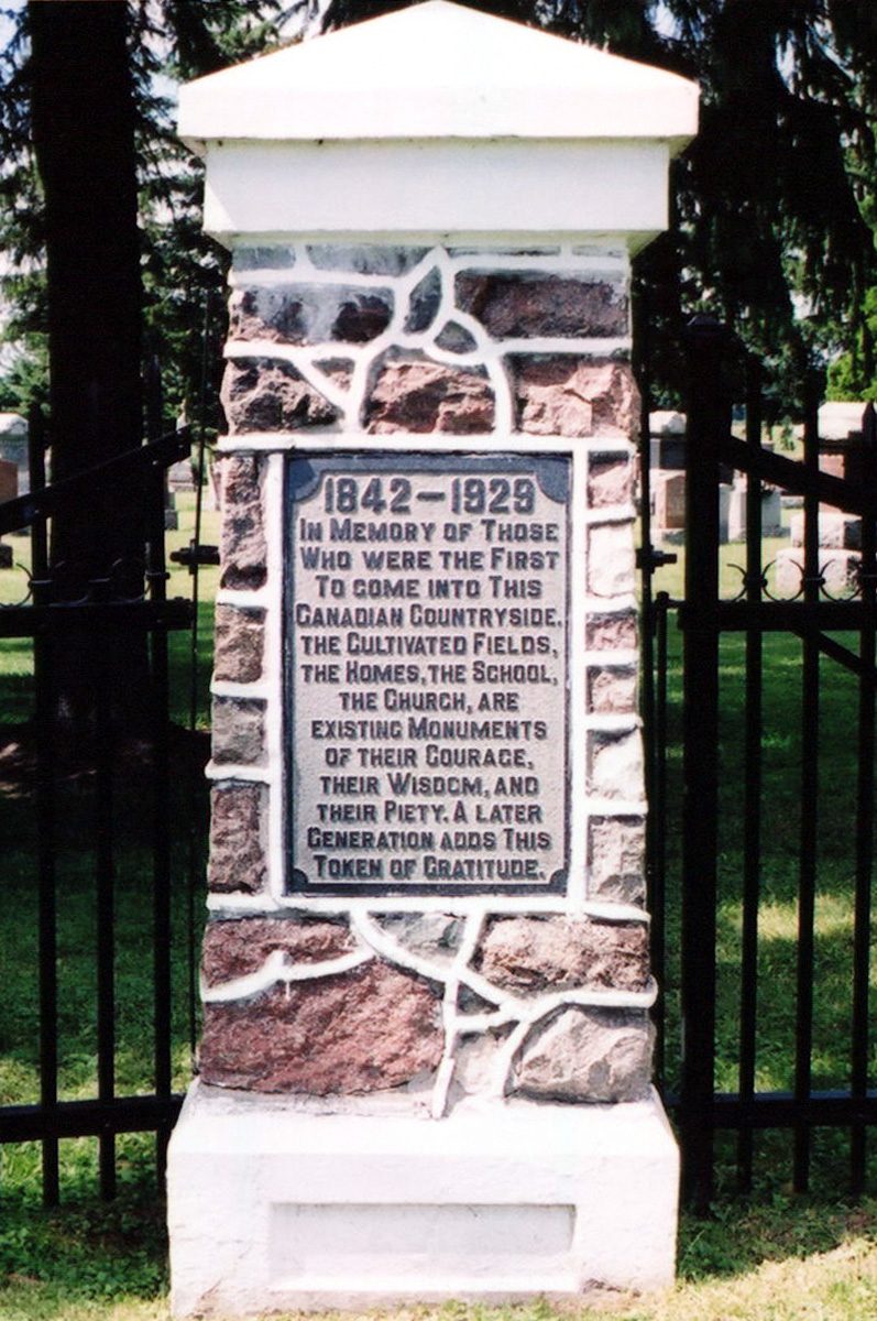 Plaque near cemetery entranceway.